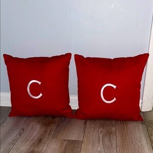 Red throw pillows with "C" monogram charm